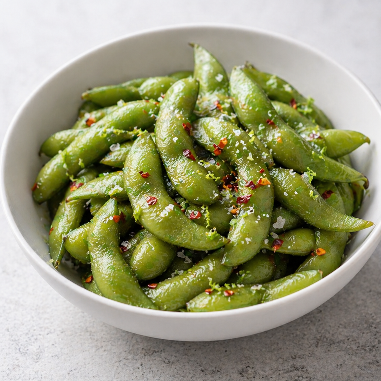 Edamame in the shell seasoned with sea salt, chili flakes, and lime zest